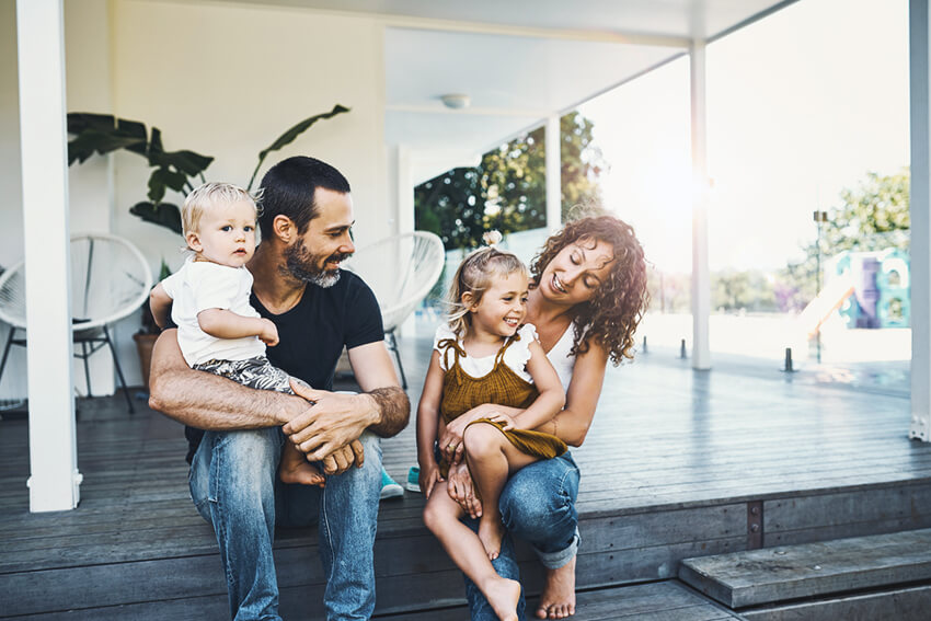 Family sitting on steps of porch