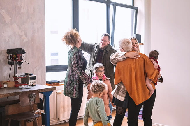 Couple welcoming family members for diner party