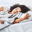 Young woman sleeping in bed