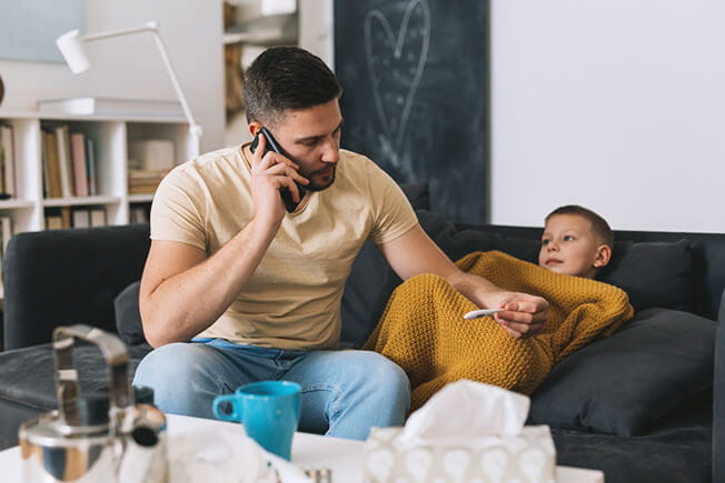 Father taking care of sick son