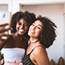 Two young women smiling and taking a selfie together.