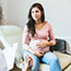 Pregnant woman speaking with a doctor.