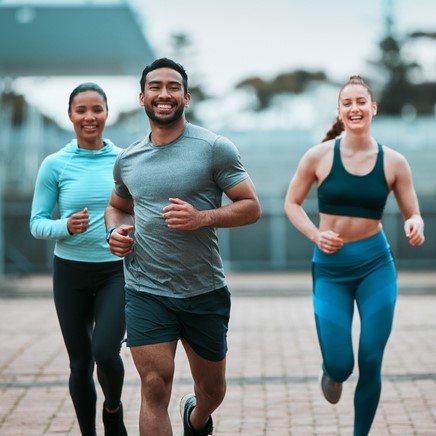 Group of friends running outdoors.