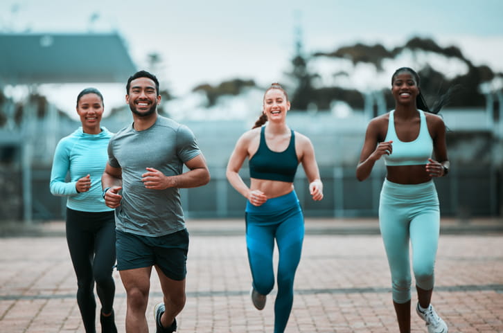 Group of friends running outdoors.