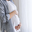 Pregnant woman holding belly