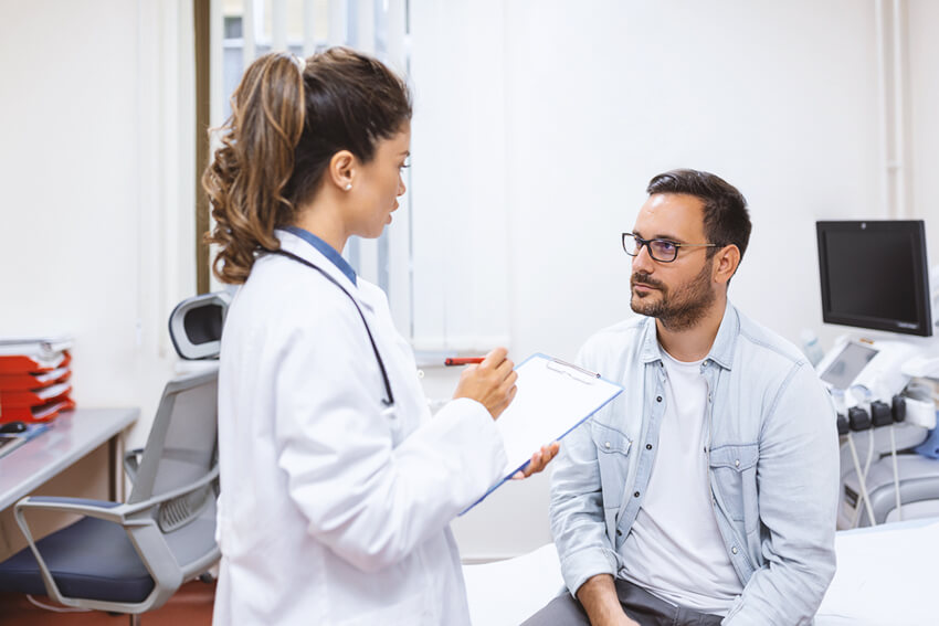 Male patient speaking with a female doctor.