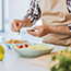 Man preparing a healthy salad at home.