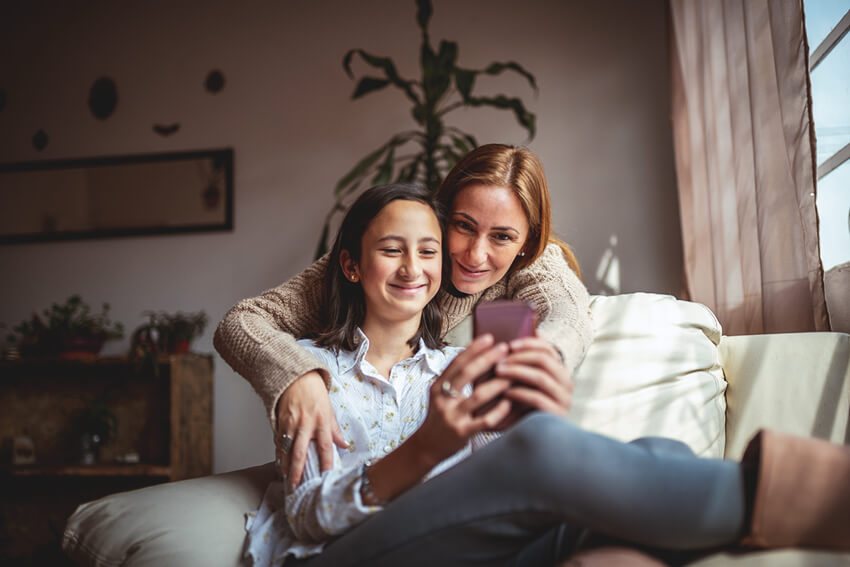 Mother and daughter using a smartphone.