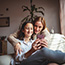 Mother and daughter using a smartphone.