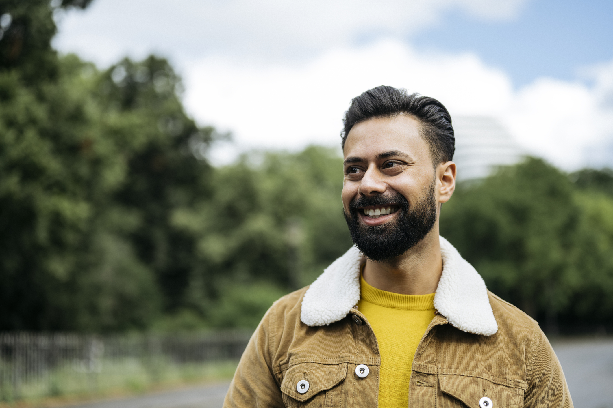 Candid portrait of early 30s man standing outdoors