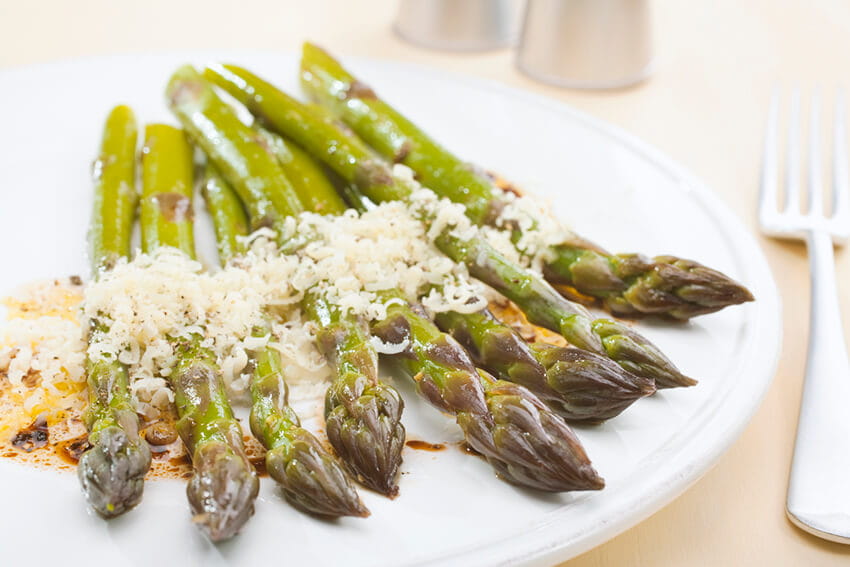 Plated asparagus with parmesan cheese.