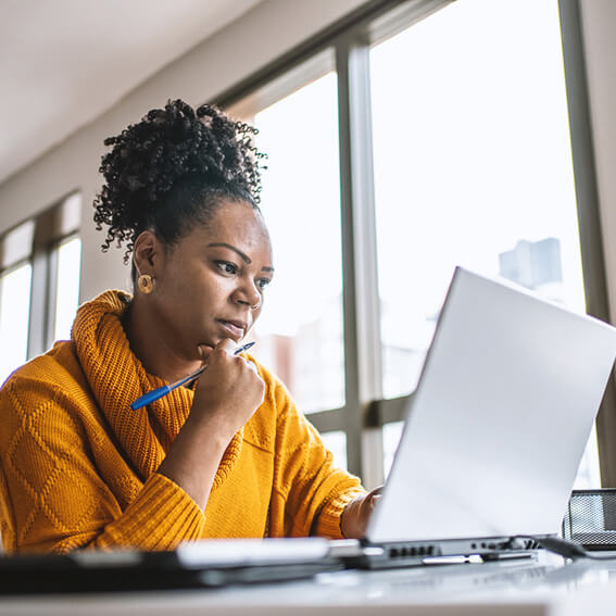 Woman on her laptop at home.