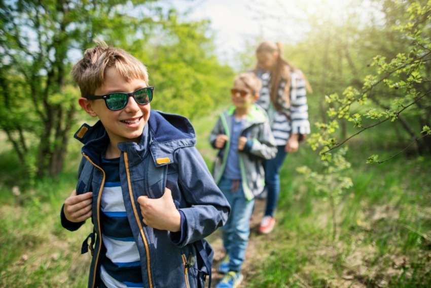 Family hiking all wearing sunglasses.