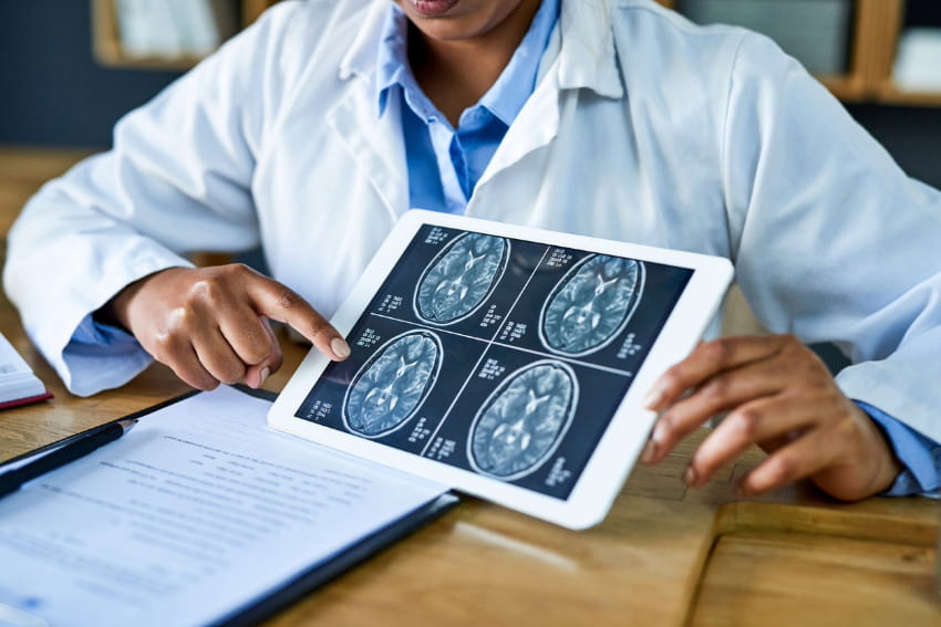 Doctor evaluating brain scan images.