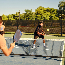 Young adults playing pickleball on a public court