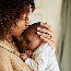 Mother kissing with her baby in her arms.