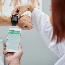 Patient with a wearable heart rate monitor and doctor helping sync it to their phone.