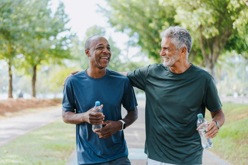 Two men walking in public park.