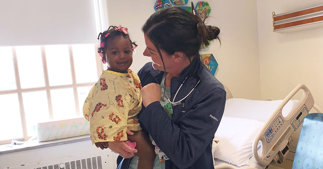Meghan Maguire with a little girl.