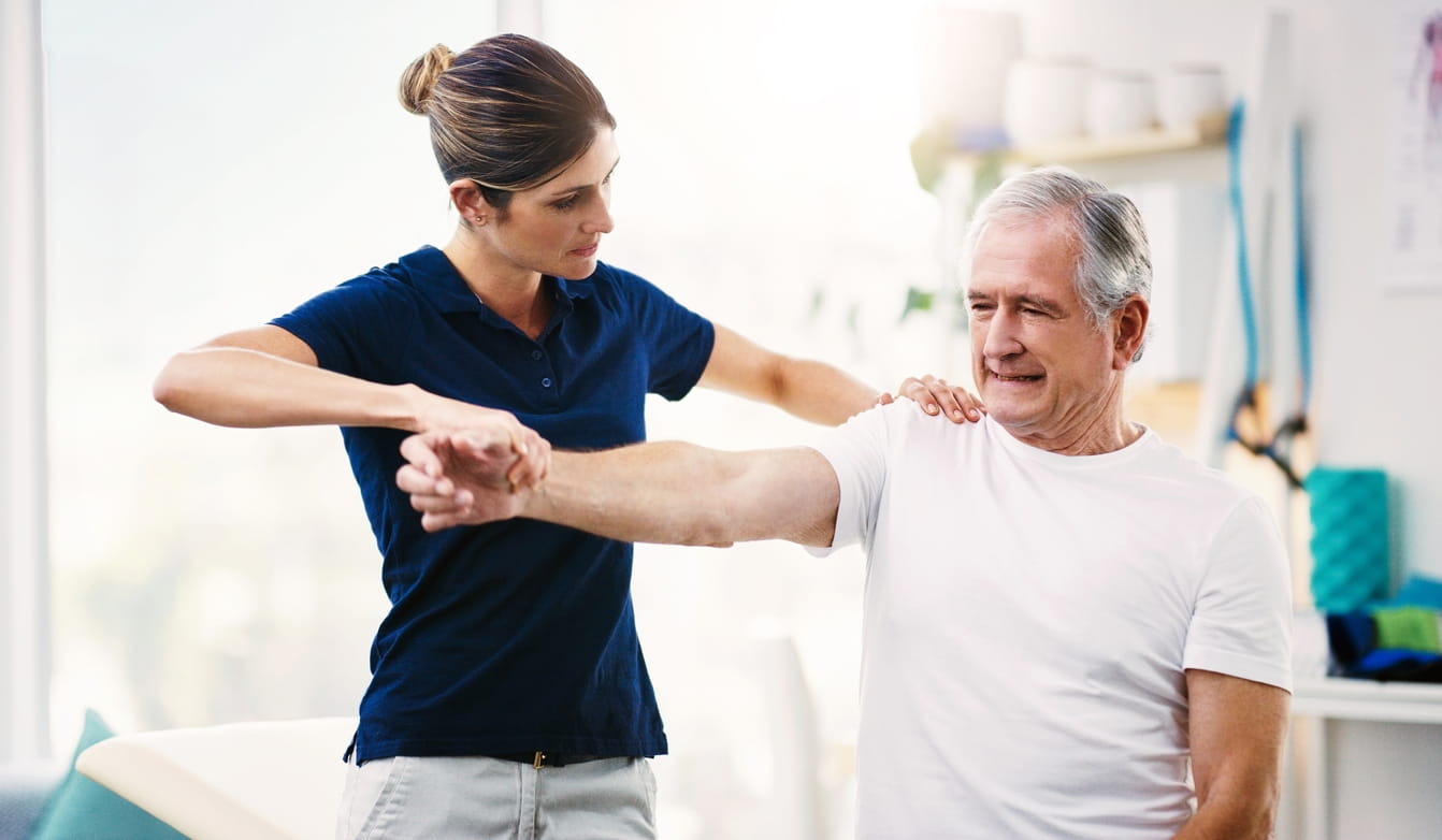 Man doing physical therapy exercises for his shoulder.