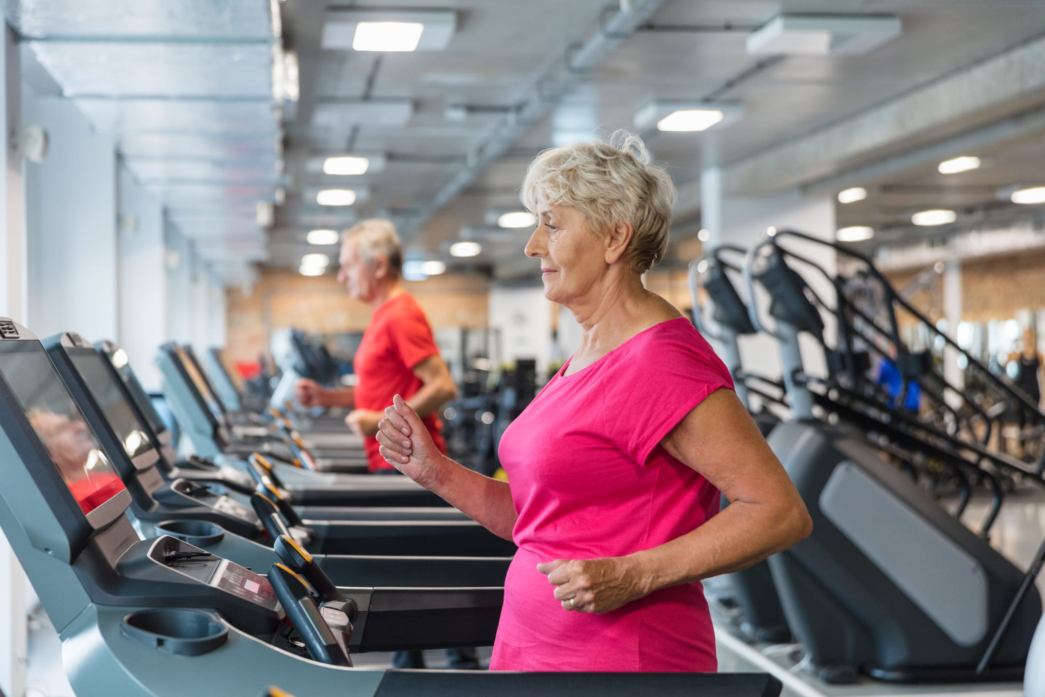 Person running on a treadmill at the gym.