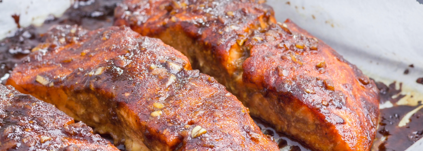 Glazed salmon on a baking sheet.