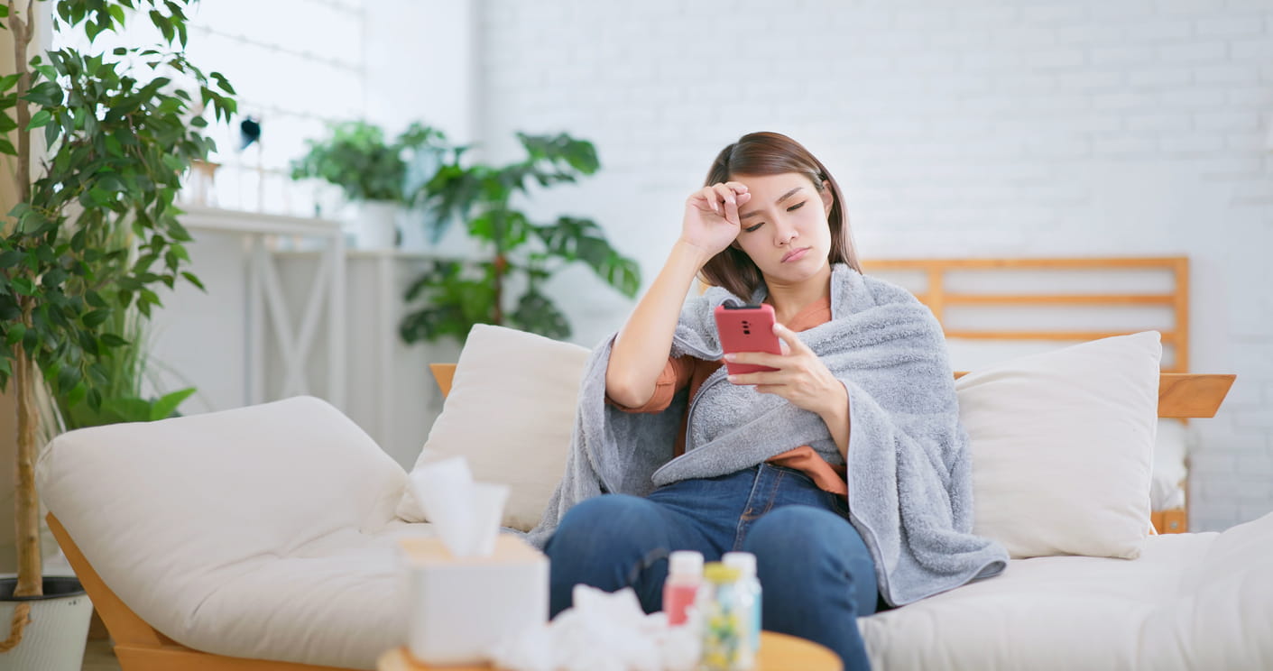 Sick woman using phone 