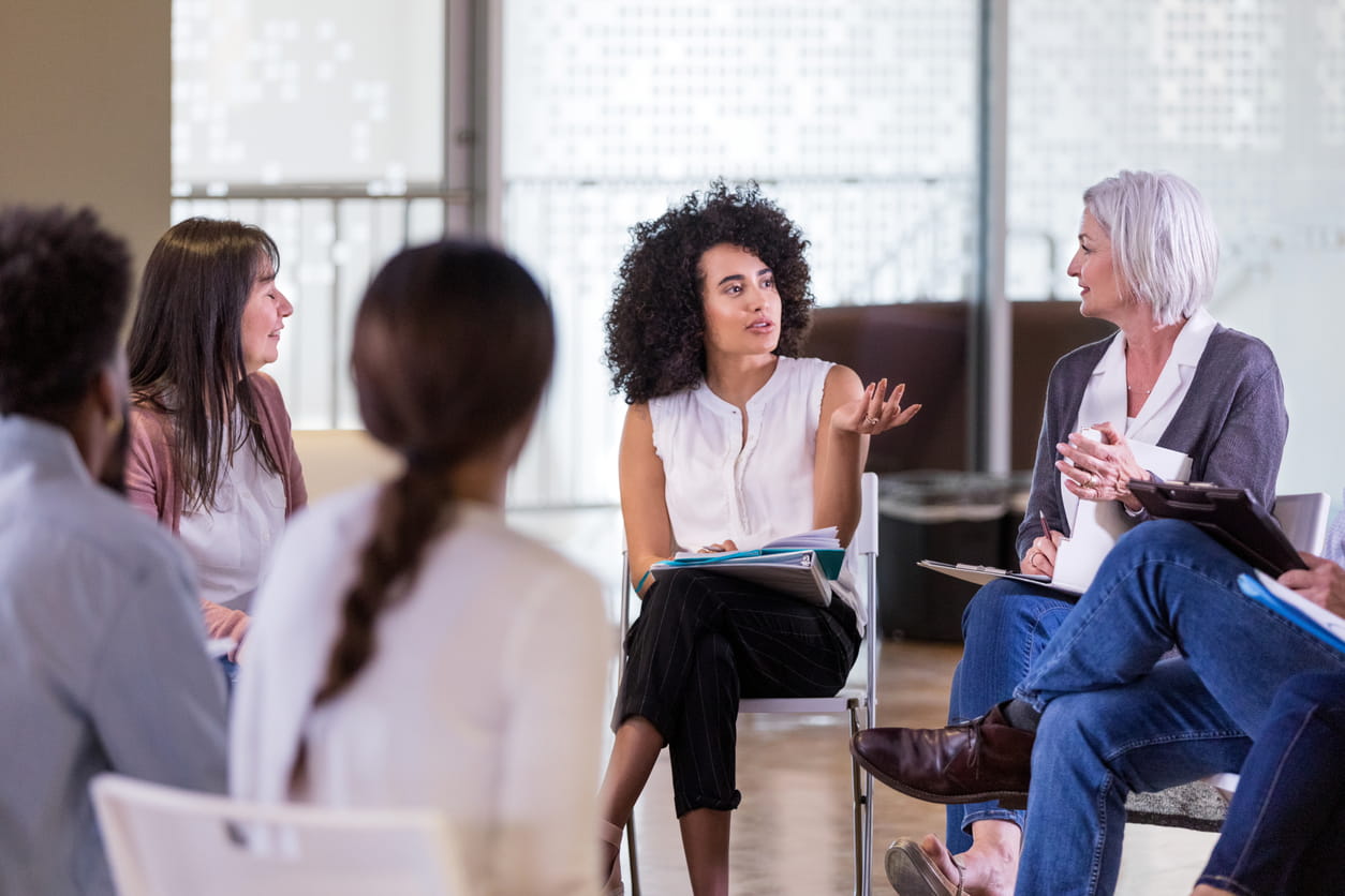 Woman talking in group therapy.