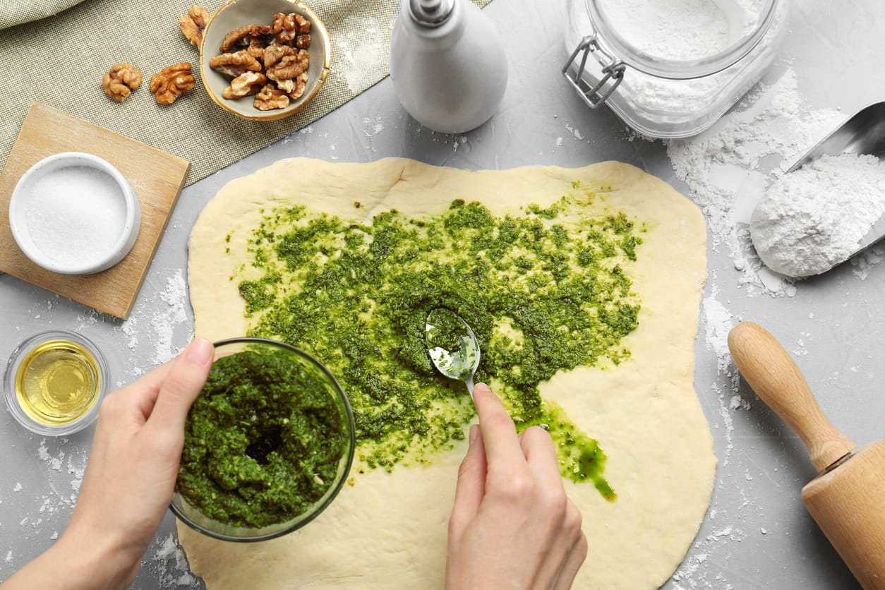 Making pesto pizza.