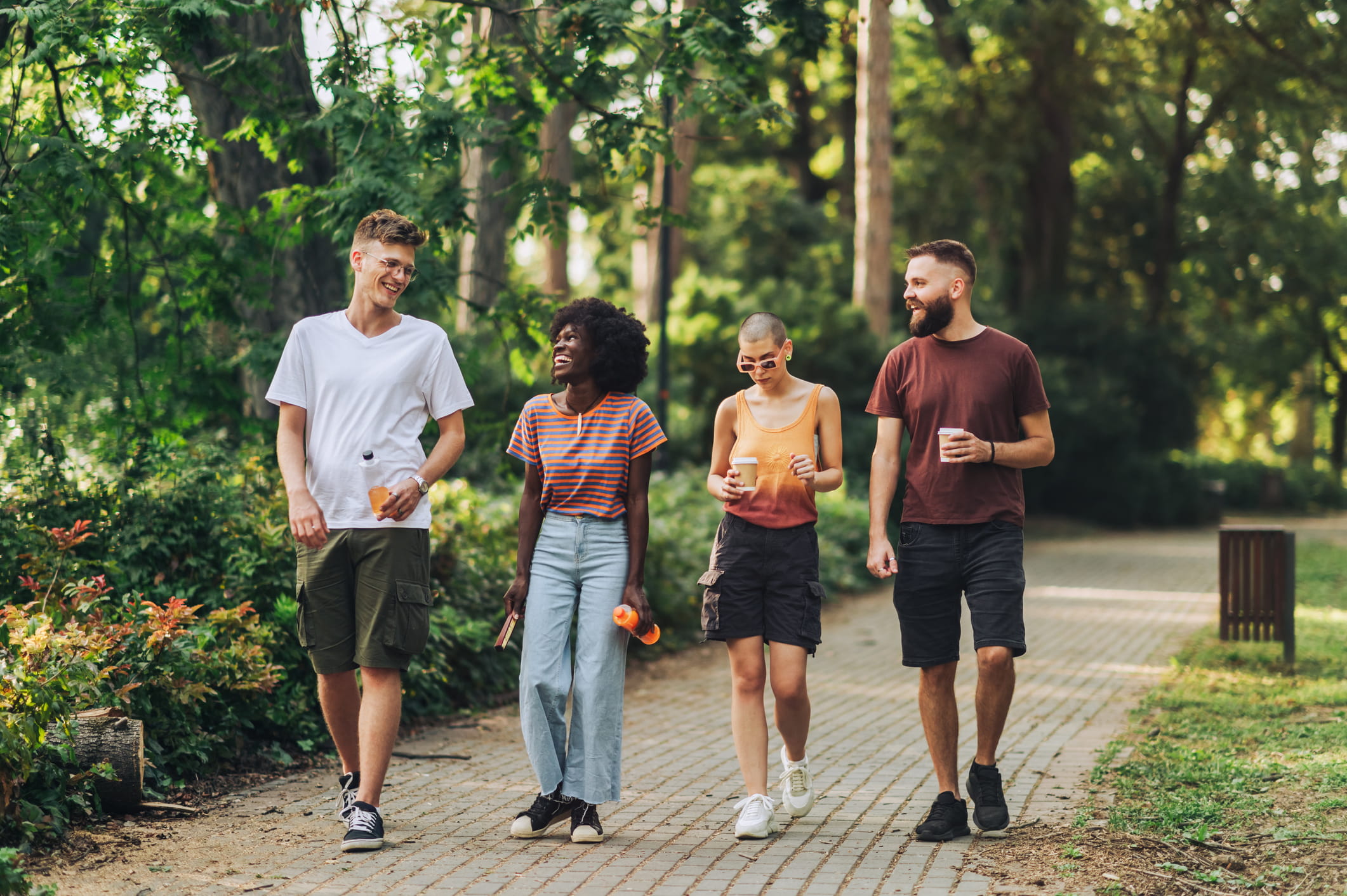 Group of four people walking outdoors.