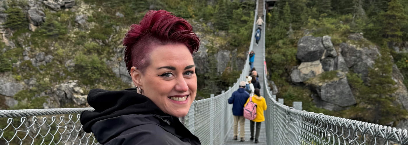 Amy standing on a bridge