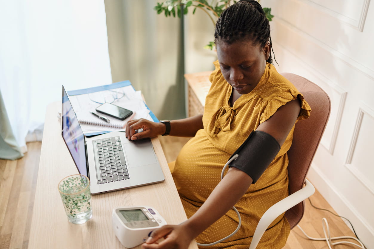 Pregnant woman checking her blood pressure
