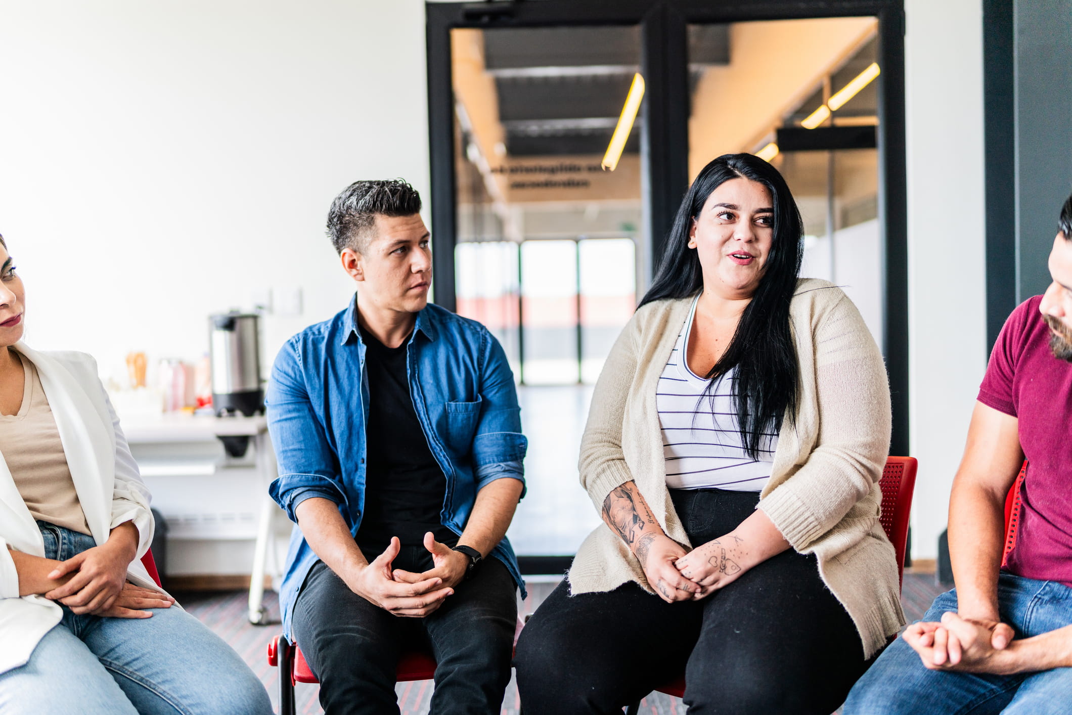 woman introducing herself in group therapy at rehab center