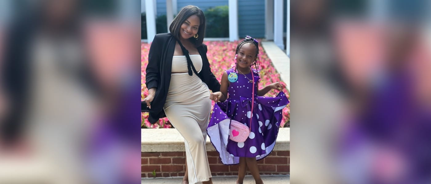 Crystal H. and her young daughter doing a curtsy in their dresses.