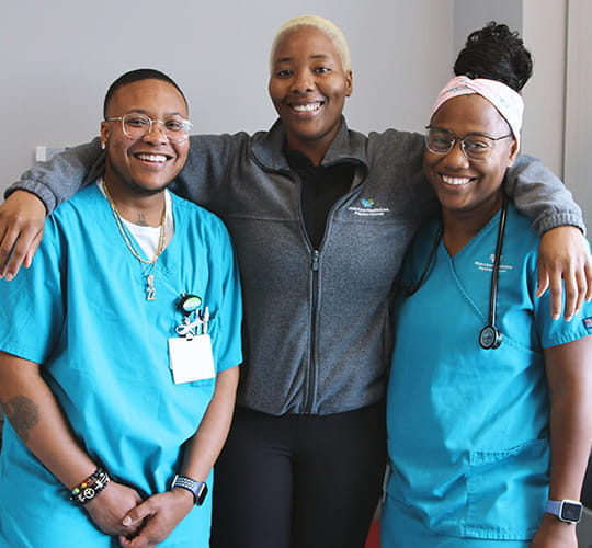 Three nurses smiling at camera