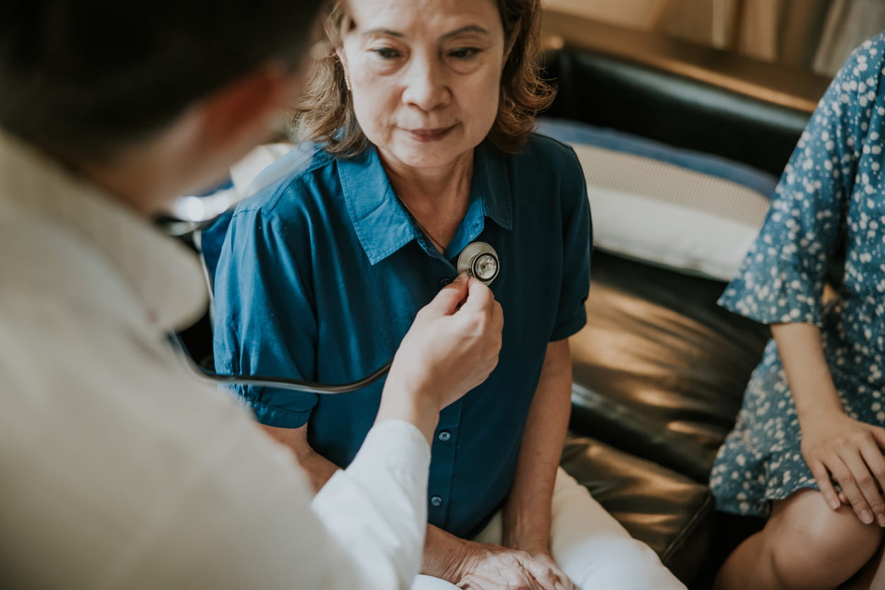 Asian Doctor concentrate on listening heartbeat
