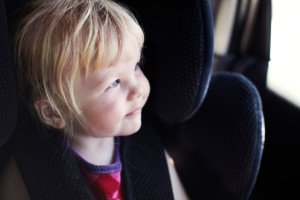child sitting in car sear in car