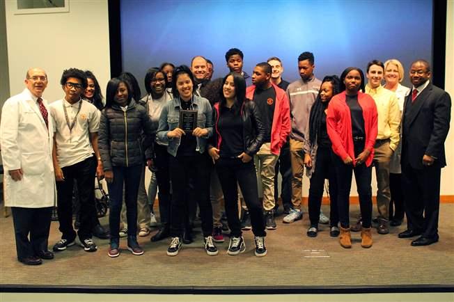 Barry Mann, MD, MLH Chief Academic Officer (left), Kathleen Martin, MSN, RN, Trauma Program Manager at Lankenau Medical Center (second from right) and Jeshahnton (Shaun) Essex, Vice President, Administration at Riddle Hospital (right) joined the students of Chester High School accepting their award at the Health Career Academy finale