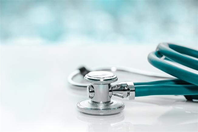 Stethoscope on a doctor&#39;s white desk on cloudy morning