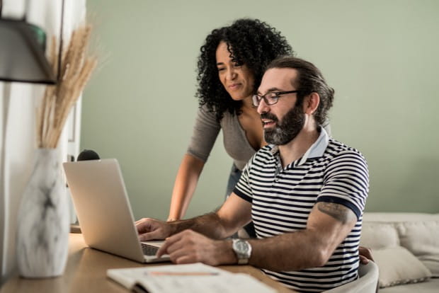 Couple looking at laptop.