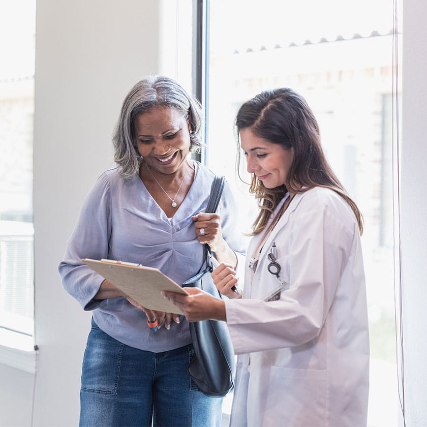 women with doctor looking at chart