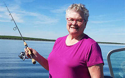 Ann enjoying fishing and "the good life" after robotic coronary bypass surgery
