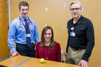 Kaylyn Sawyer with Dr. Brian McDonald (left) and therapist Clint Beckley (right)