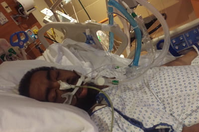 Milike Johns laying in a hospital bed