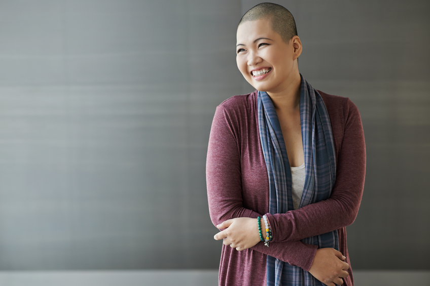 woman with shaved head smiling
