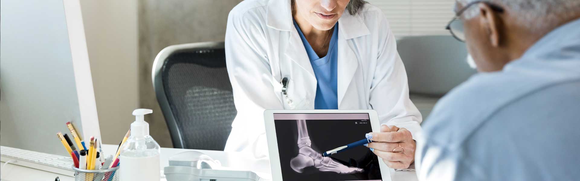 doctor showing patient foot xray