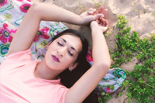 girl laying on blanket with eyes closed