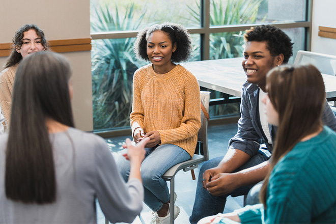 Young adults sitting in a small group