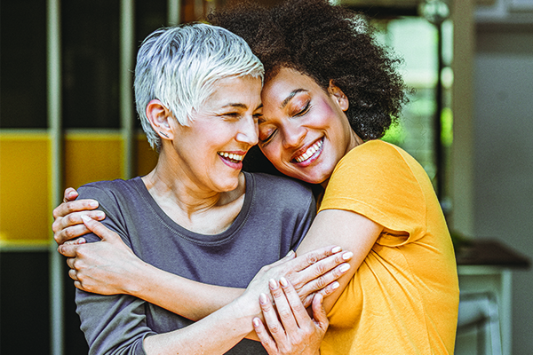 A mother and daughter hugging.