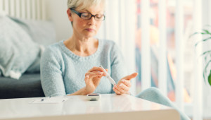 older woman using blood sugar monitor